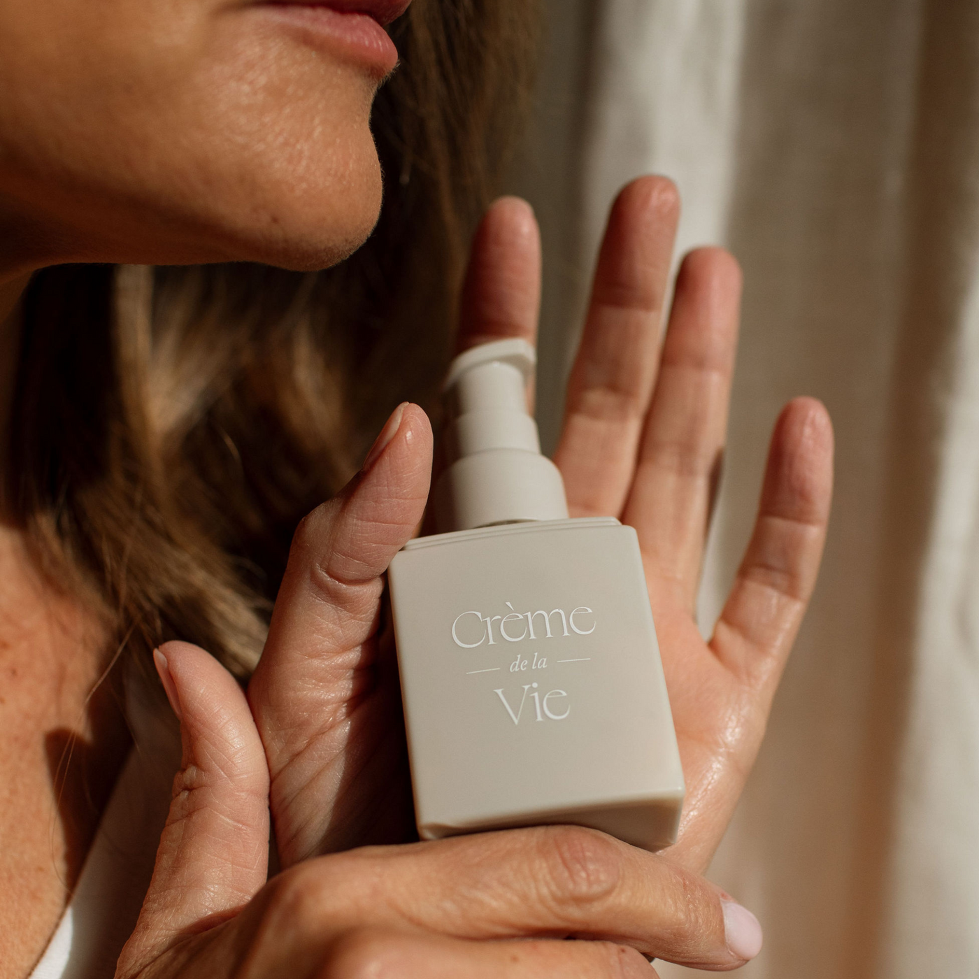 A photo of a woman holding creme de la vie